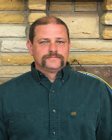 Anthony Taylor Service Department, man with brown hair and mustache wearing a green button up shirt