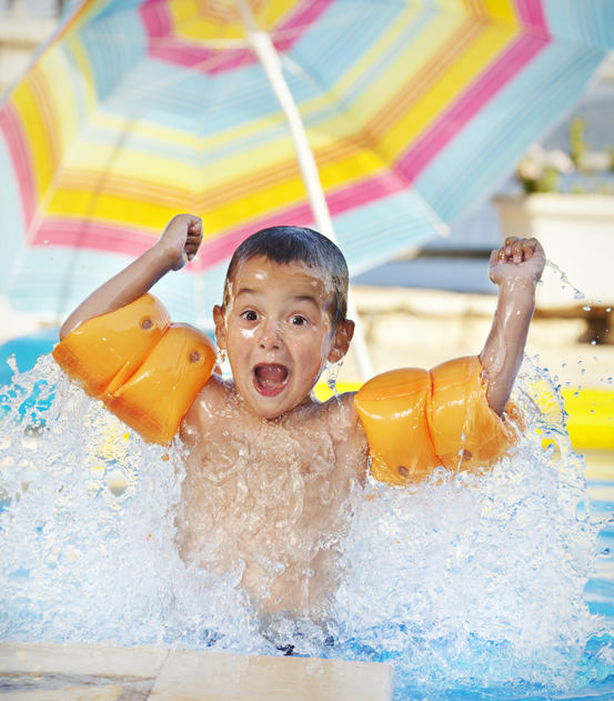 Child splashing happily in the Pleasantville Pool